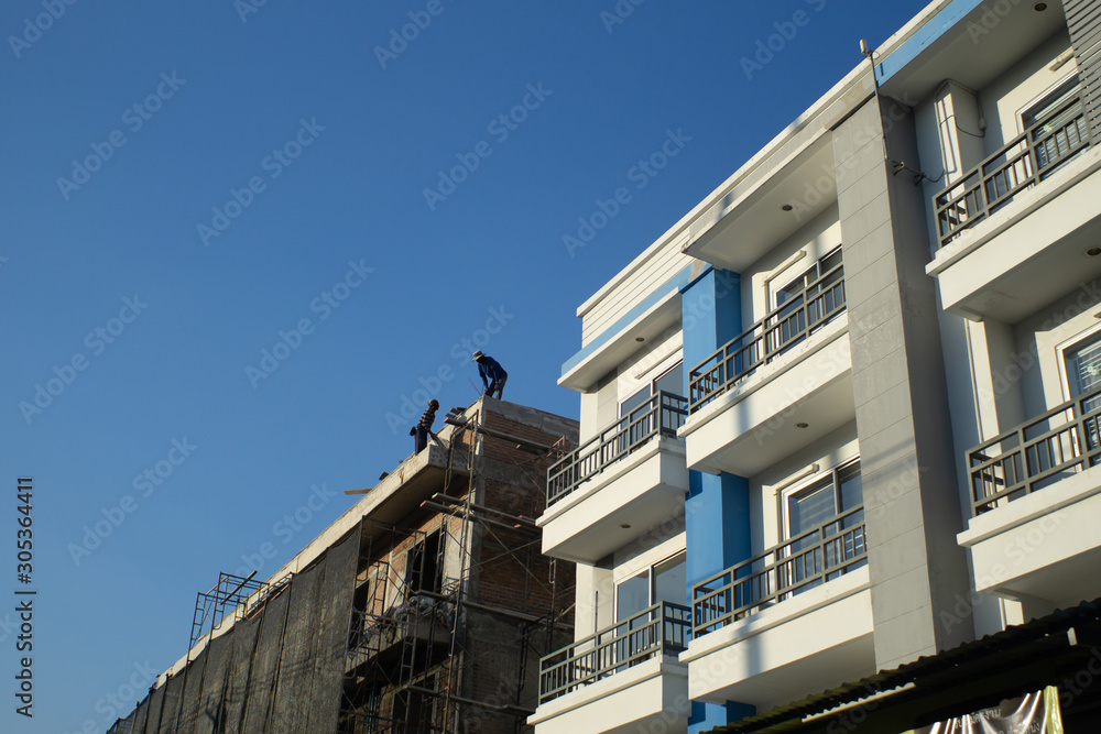 Compare between under construction building and complete shophouse building