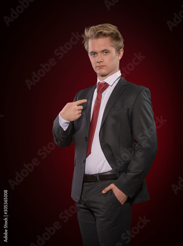 Proud young business man in businesslike suit and tie