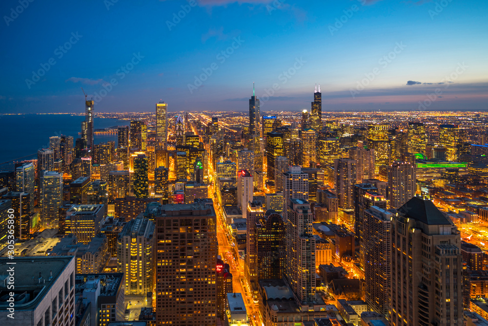 Beautiful scenic view of business district of Chicago loop with skyline in evening sunlight. Panoramic view aerial top view or drone architecture view of city. Famous attraction in Chicago, USA.