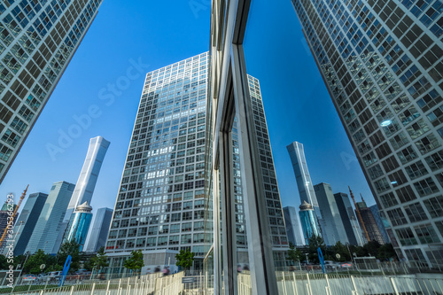 Buildings reflected in windows of modern office building © hallojulie