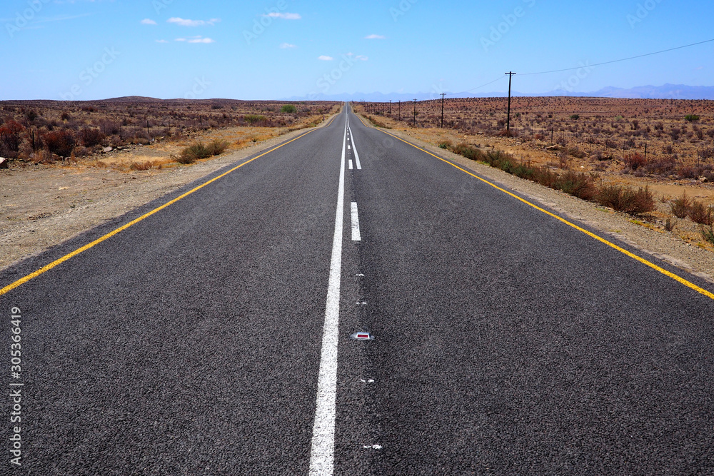 Wide open road in an arid landscape Wide open road in an arid landscape