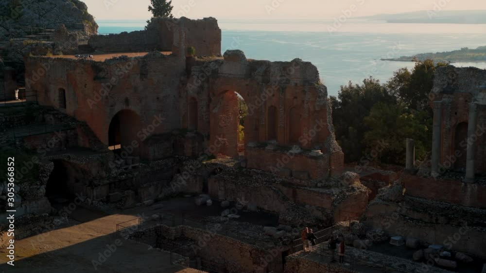 The Greek Roman theater in Taormina with the East coast of Sicily in the background