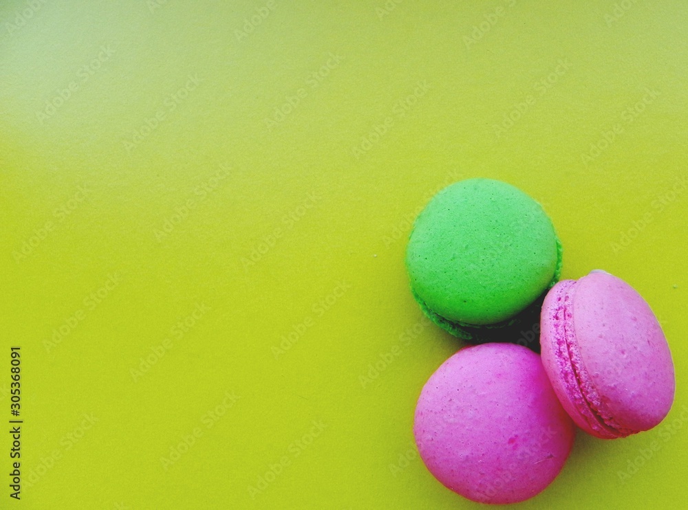 Bright sweet macaroon cookies on a yellow background with space for text Bright sweet macaroon cookies on a yellow background with space for text
