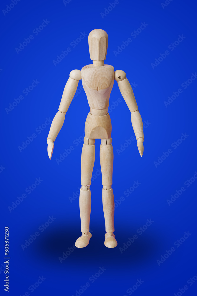 Standing wooden toy figure on blue Standing wooden toy figure on blue