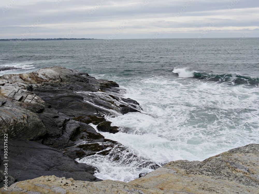 Foaming waves rolling toward rocky shores