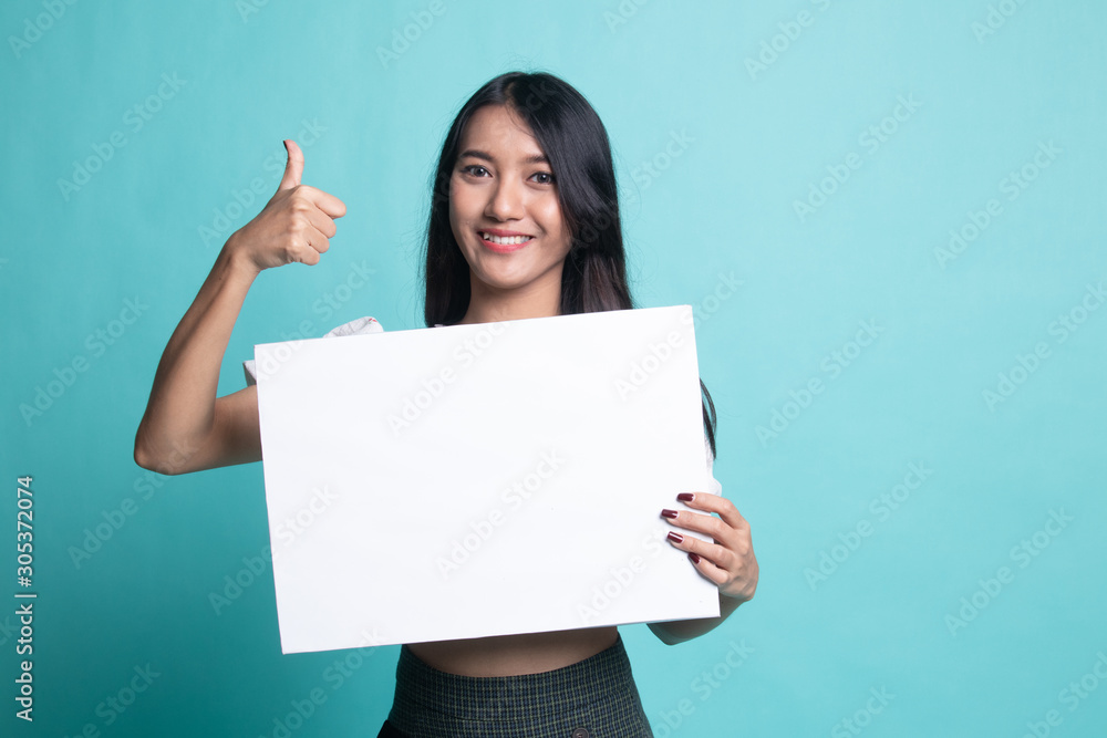 Young Asian woman show thumbs up with white blank sign Young Asian woman show thumbs up with white blank sign