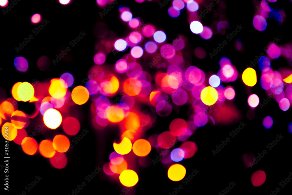 Colorful circles bokeh festive glitter dark background. Holiday greeting cards, invitations, flyers, blog posts, banners design. Christmas lights bokeh overlay.	