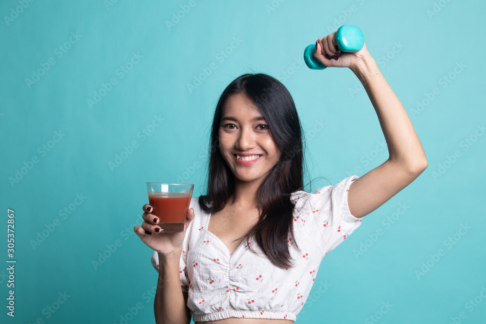 Healthy Asian woman with dumbbell and tomato juice. Healthy Asian woman with dumbbell and tomato juice.