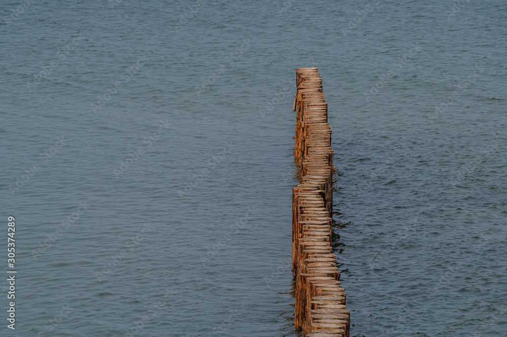 New wooden breakwater on a cloudy day