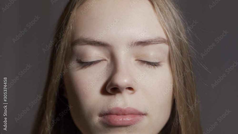 Close-up of beautiful gray female eyes. The girl opens her eyes Close-up of beautiful gray female eyes. The girl opens her eyes