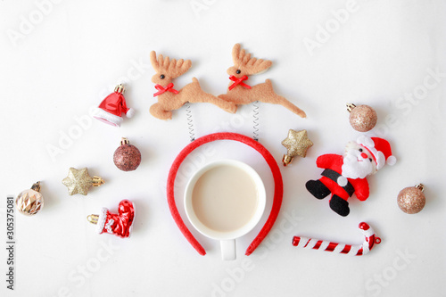 Coffee with Christmas ornament and fancy headband with reindeer decorative shape for Christmas party and celebration on white background.