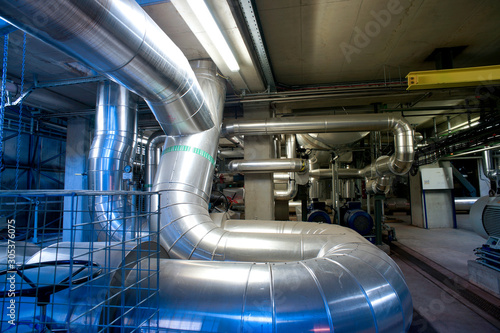 Equipment, cables and piping as found inside of a modern industrial power plant