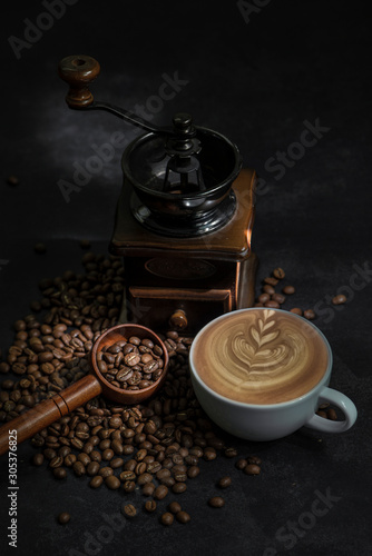 Latte art coffee and coffee beans on table