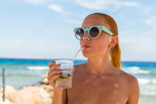 Young woman with mojito