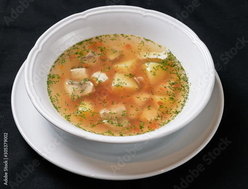 fish soup in a white plate