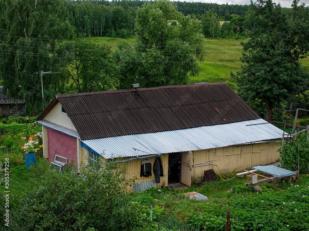 old wooden houses in summer in the village, Russia. old wooden houses in summer in the village, Russia.