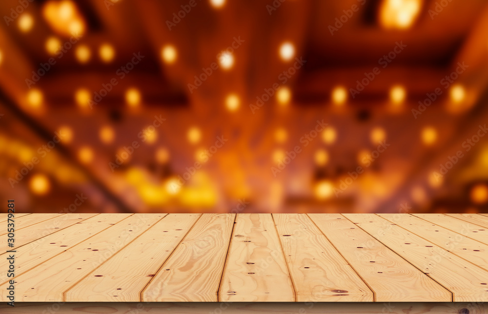 Blurred wooden table, yellow background light at night in the meeting room, night for editing product pictures or layout design