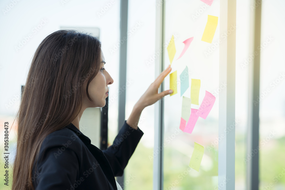 Businesswoman working in office in action thinking with sticky note to do list using as background professional business people, successful business woman consultant concept. Businesswoman working in office in action thinking with sticky note to do list using as background professional business people, successful business woman consultant concept.