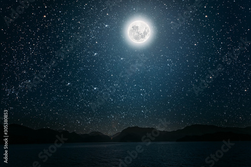 Wallpaper Mural moon against a bright night starry sky reflected in the sea