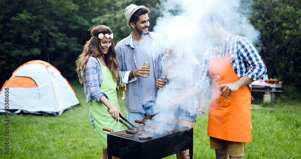 Happy people having camping and having bbq party Happy people having camping and having bbq party