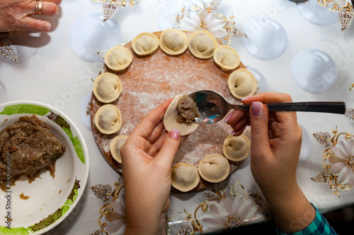 woman preparing dumplings hands