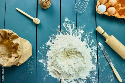 Baking ingredients background, baking concept, top view. Copy space. Falt lay. Raw dough for cookies. Kitchen utensils and ingredients for cooking baking photo