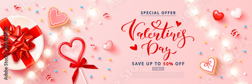 Fotografie, Obraz Valentine's day sale background with Red heart lollipop,cookies, streamers,gift box and garland