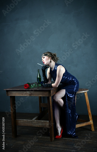 girl in evening blue dress with a cigarette