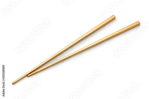 Golden chopsticks isolated on white background