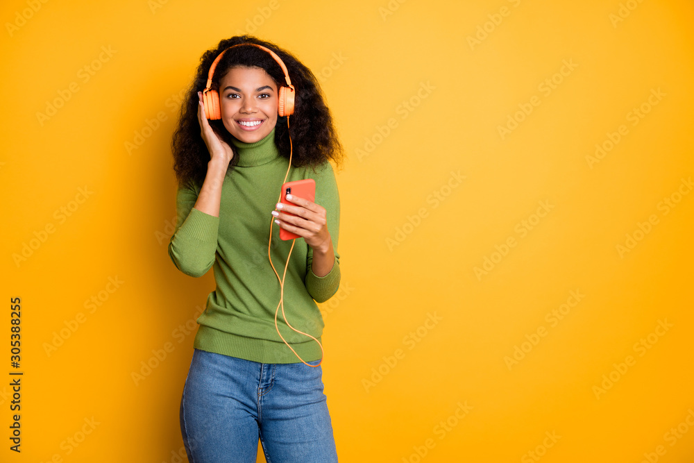 Photo of trendy cheerful positive cute pretty girlfriend youngster standing near empty space smile toothy in jeans denim curly wavy isolated vivid color background Photo of trendy cheerful positive cute pretty girlfriend youngster standing near empty space smile toothy in jeans denim curly wavy isolated vivid color background