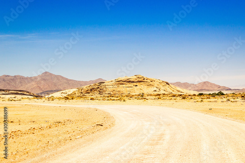 Gravel road that leads to the granite mountain Blutkuppe  Naukluft Park  Namibia  Africa