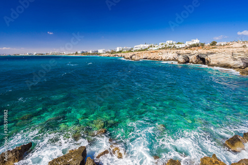 Rocky shore, clear turquoise sea water and blue sky in Ayia-Napa, Cyprus. photo