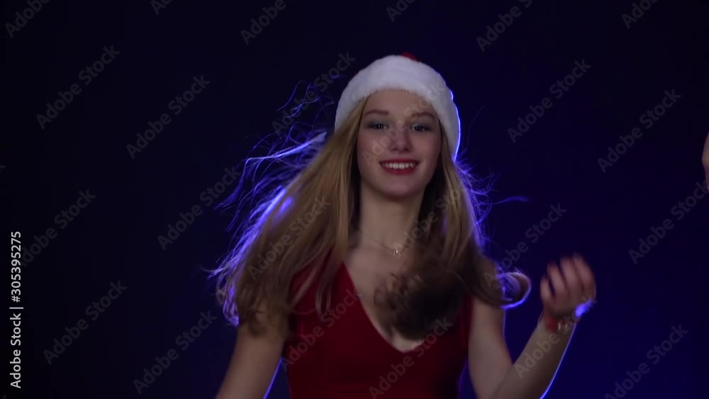 Girls in caps of the snow maiden are dancing . Smoky colorful background. Slow motion Girls in caps of the snow maiden are dancing . Smoky colorful background. Slow motion