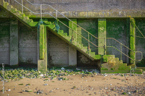 Mossed concrete steps to the foreshore of river Thames in London photo