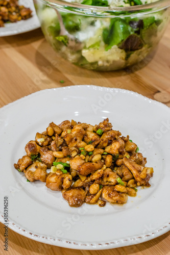 Homemade Kung Pao Chicken with Peanuts, Peppers, Soy Sauce, Green Chives and Veggies.