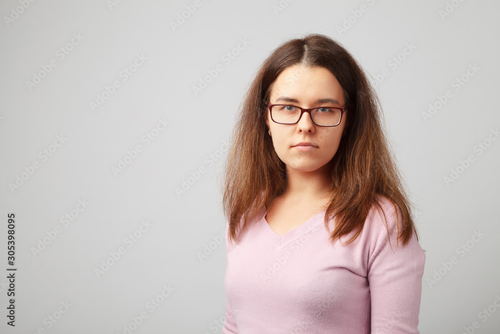 Head and shoulder portrait of brunette young woman with glasses