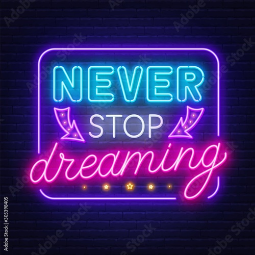 Never stop dreaming neon sign on a dark background.