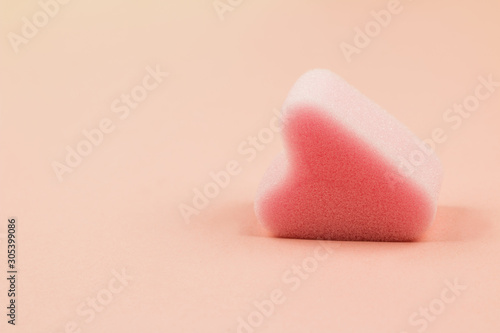 Close up of menstrual sponge tampon on pink background