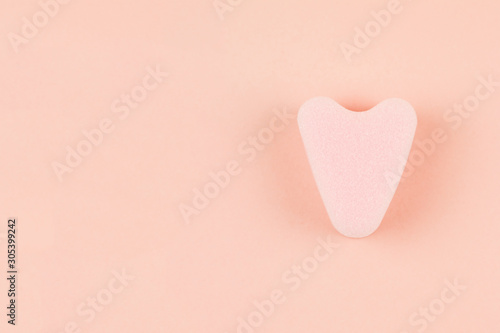 Close up of menstrual sponge tampon on pink background