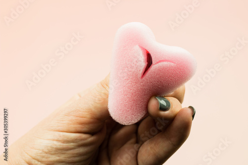 Close up of woman hand holding menstrual sponge tampon in packag
