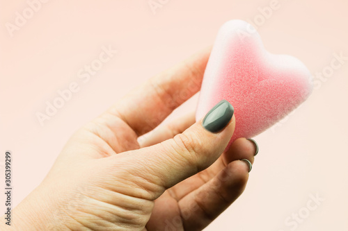 Close up of woman hand holding menstrual sponge tampon in packag