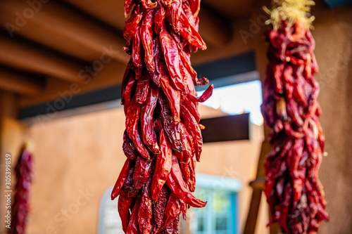 Red chili peppers dried hanging on a traditional building entrance, Santa Fe New Mexico photo