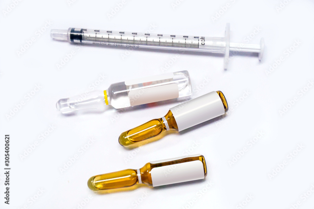 3 ml. brown Ampules of drug and plastic syringe on white background. 3 ml. brown Ampules of drug and plastic syringe on white background.