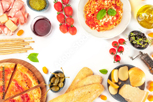 Italian food. Pizza  pasta  cheese  hams  olives and olive oil  shot from the top on a white background  forming a frame with a place for text  a flat lay composition