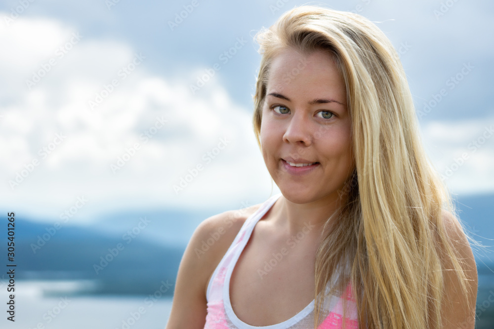 Beautiful girl with blonde hair and green eyes are smiling outdoors in nature. Fitness model and sport concept. Copy space for text. Beautiful girl with blonde hair and green eyes are smiling outdoors in nature. Fitness model and sport concept. Copy space for text.