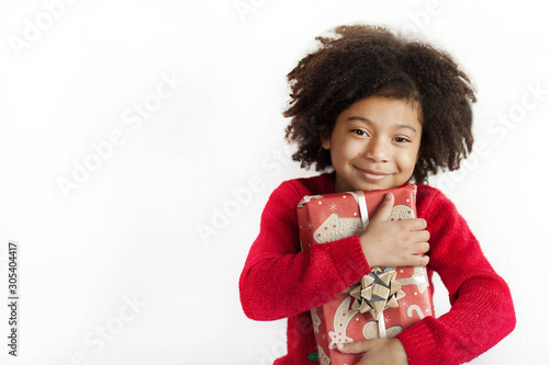 Happy adorable african american child girl  with christmas gift in hands isolated on white background