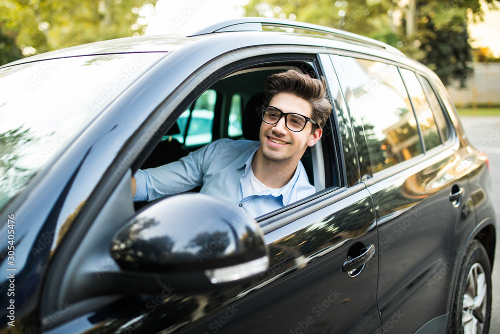 Portrait of an handsome man driving his car Portrait of an handsome man driving his car