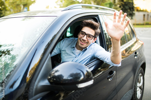 Happy man driving car and waving hand © F8  \ Suport Ukraine