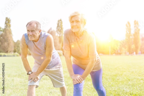 Determined senior couple exercising together in park