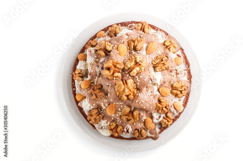 Homemade cake with milk cream, cocoa, almond, hazelnut isolated on white background. Top view.
